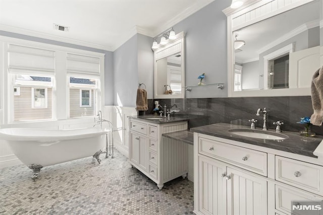 bathroom with two vanities, visible vents, crown molding, and a sink