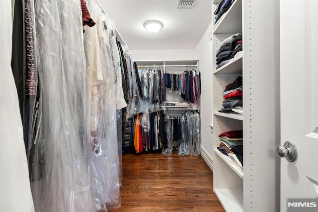 walk in closet featuring visible vents and wood finished floors