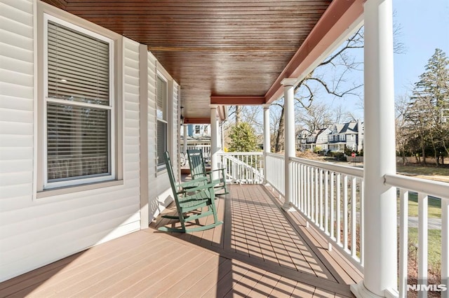 wooden terrace featuring covered porch