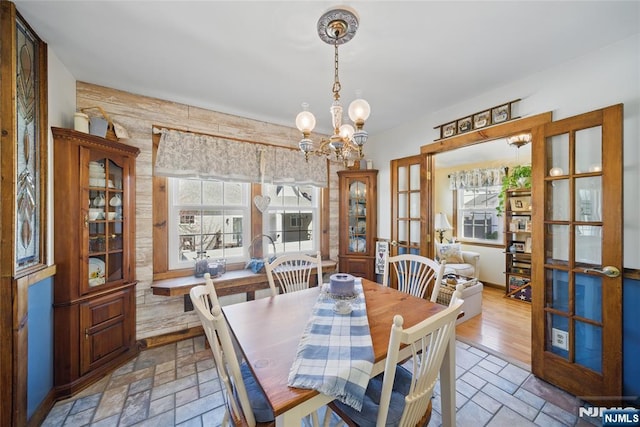 dining room with a notable chandelier and french doors