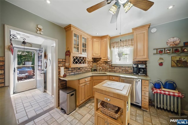 kitchen featuring a sink, decorative backsplash, plenty of natural light, and dishwasher