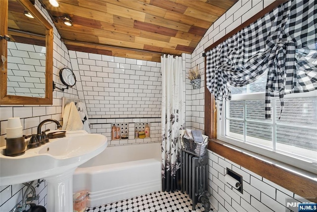 full bath with lofted ceiling, tile walls, wood ceiling, and shower / tub combo