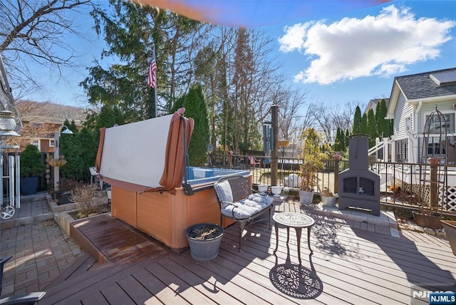 wooden terrace featuring a hot tub