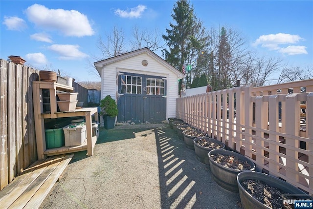 exterior space featuring a storage unit and fence