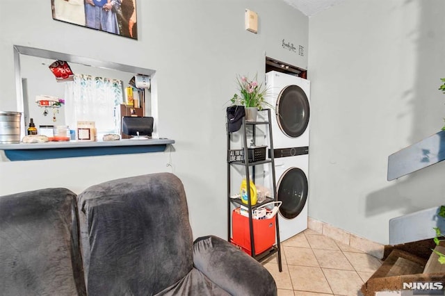 interior space featuring tile patterned floors and stacked washing maching and dryer