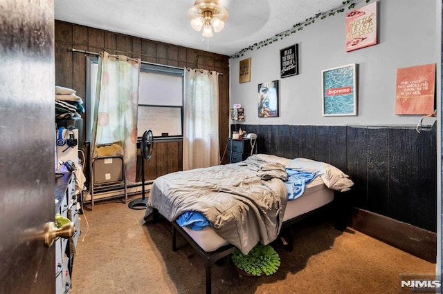 carpeted bedroom featuring a wainscoted wall and wooden walls