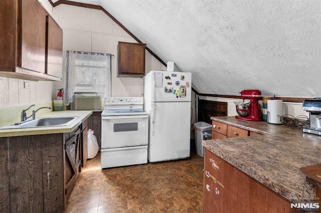 kitchen featuring a sink, white appliances, a textured ceiling, and lofted ceiling