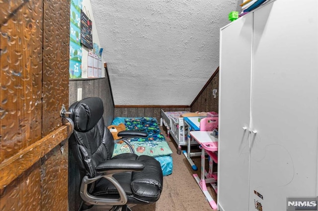 bedroom with lofted ceiling and a textured ceiling