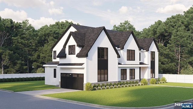 view of front facade with a front lawn, concrete driveway, fence, and a garage