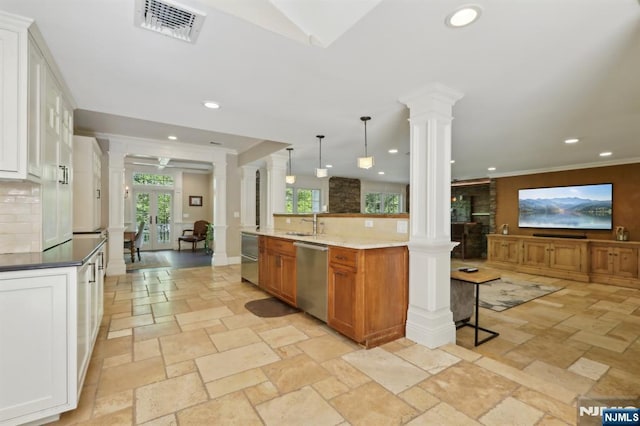 kitchen featuring ornate columns, stone tile floors, dishwasher, and visible vents