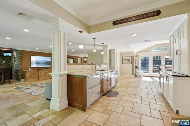 kitchen featuring decorative columns, visible vents, and dishwasher