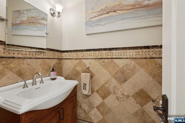 bathroom with a wainscoted wall and vanity