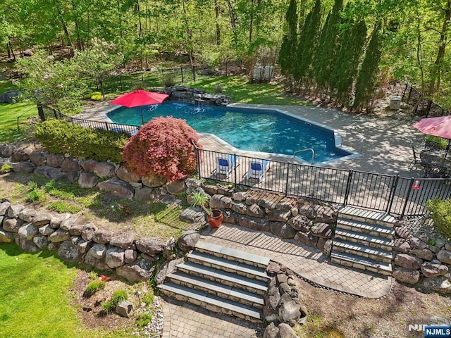 view of swimming pool featuring fence and a fenced in pool