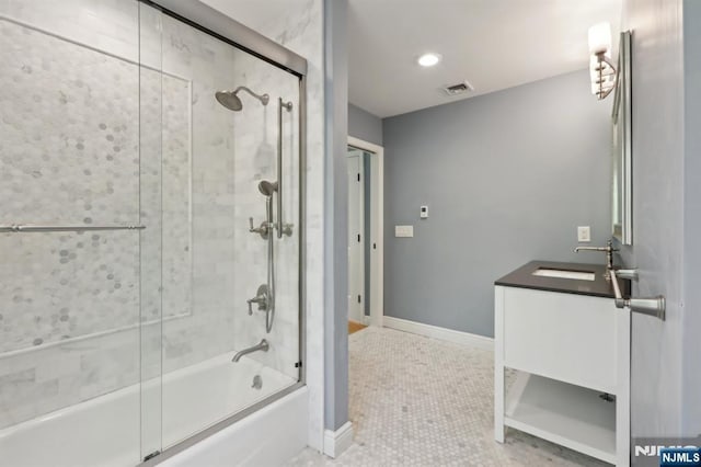 bathroom with visible vents, tile patterned flooring, vanity, baseboards, and combined bath / shower with glass door