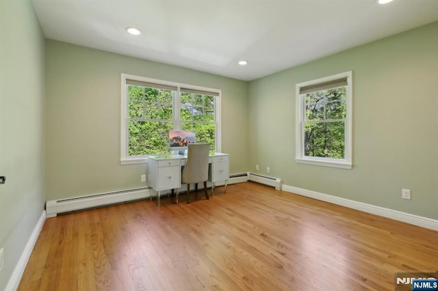 unfurnished office featuring baseboard heating, wood finished floors, baseboards, a baseboard radiator, and recessed lighting