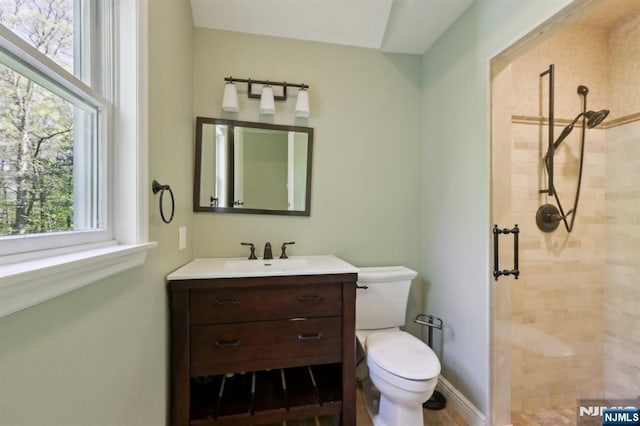full bath featuring vanity, toilet, and a stall shower