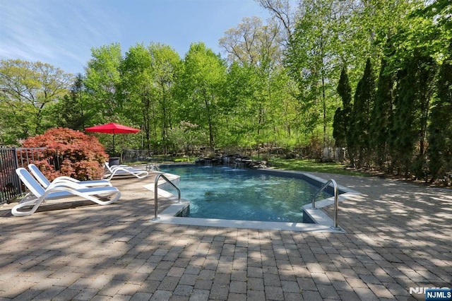 view of swimming pool with a patio, fence, and a fenced in pool