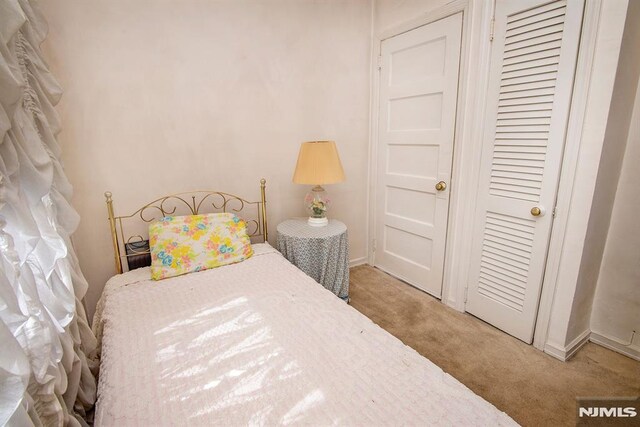 carpeted bedroom featuring baseboards