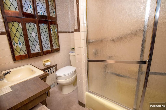 full bathroom featuring toilet, radiator, and tile walls