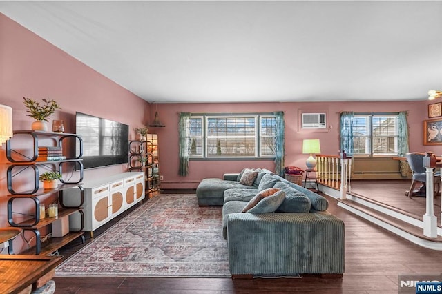 living area featuring a baseboard radiator, a wall mounted air conditioner, and wood finished floors