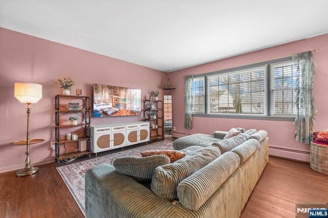 living room featuring baseboards, baseboard heating, and wood finished floors