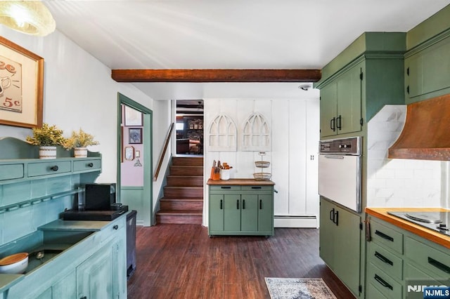 kitchen with tasteful backsplash, oven, dark wood-type flooring, and green cabinetry