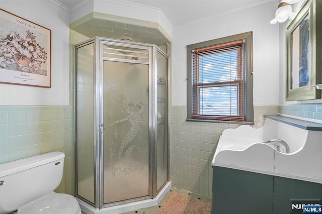 full bathroom featuring tile walls, a stall shower, and vanity