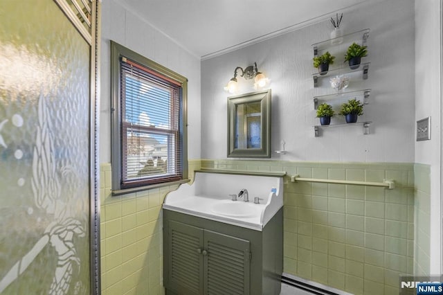 bathroom with tile walls, wainscoting, and vanity