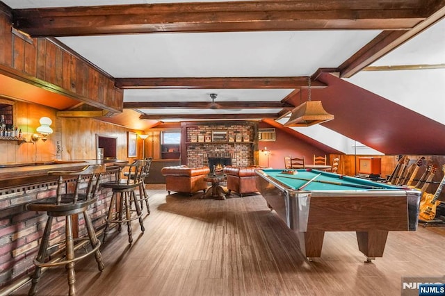 rec room featuring billiards, lofted ceiling with beams, wood finished floors, wood walls, and a fireplace