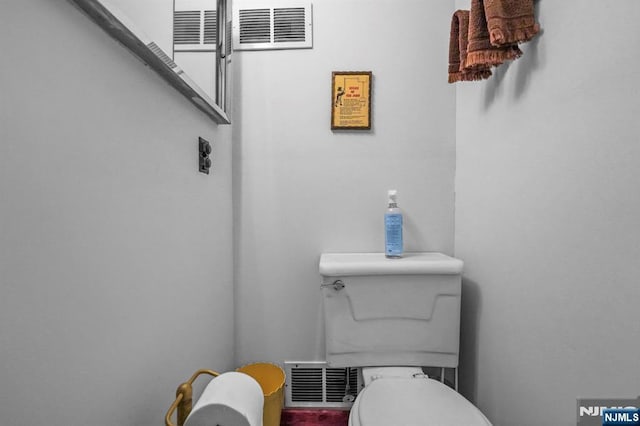 bathroom with visible vents and toilet