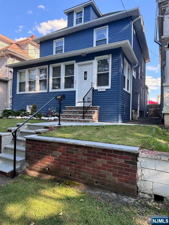 traditional style home with entry steps and a front yard