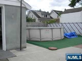 exterior space with an outdoor pool and fence