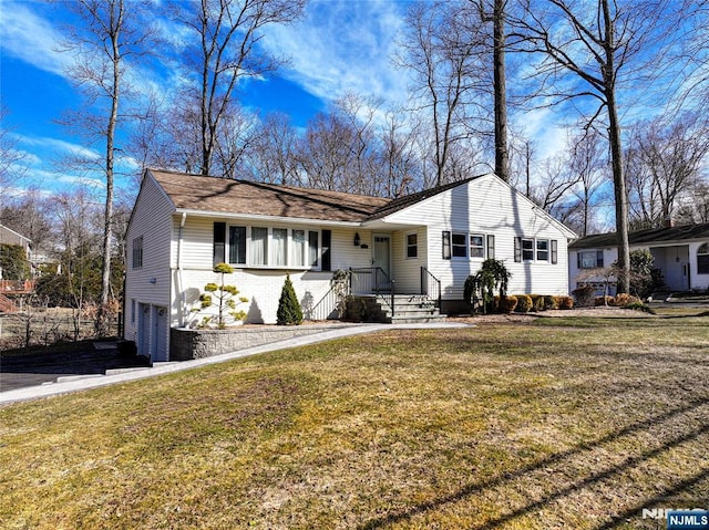 ranch-style home with brick siding, an attached garage, driveway, and a front yard