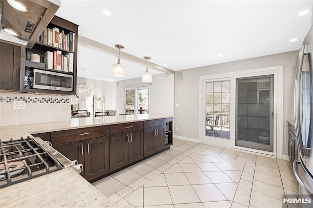 kitchen featuring light tile patterned floors, stainless steel appliances, dark brown cabinetry, decorative light fixtures, and tasteful backsplash