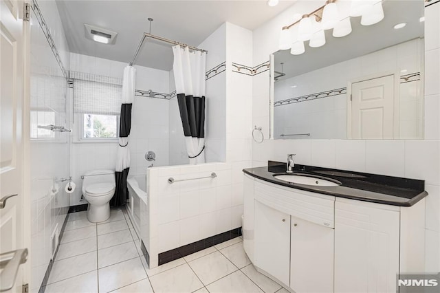 full bath with tile patterned flooring, tile walls, toilet, and shower / bathtub combination with curtain