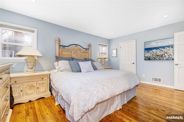 bedroom with light wood-type flooring, visible vents, baseboards, and recessed lighting