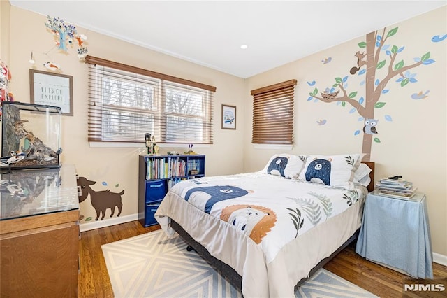 bedroom with baseboards and wood finished floors