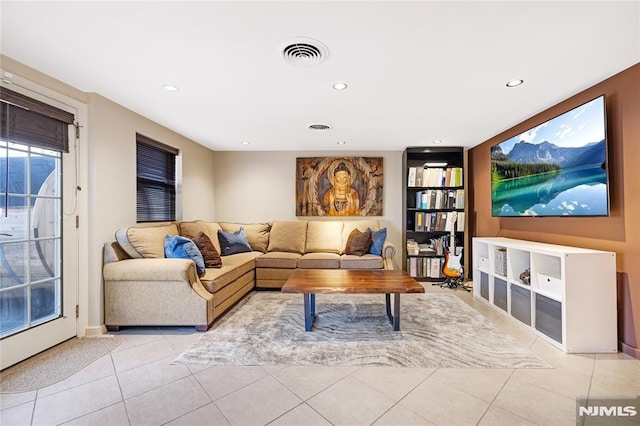 living room featuring light tile patterned floors, visible vents, and recessed lighting