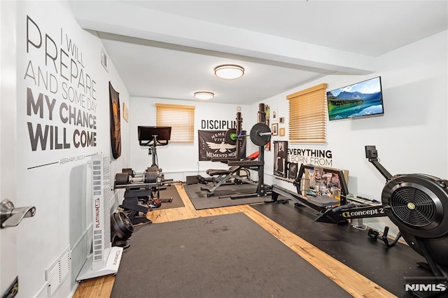 workout area featuring wood finished floors and visible vents