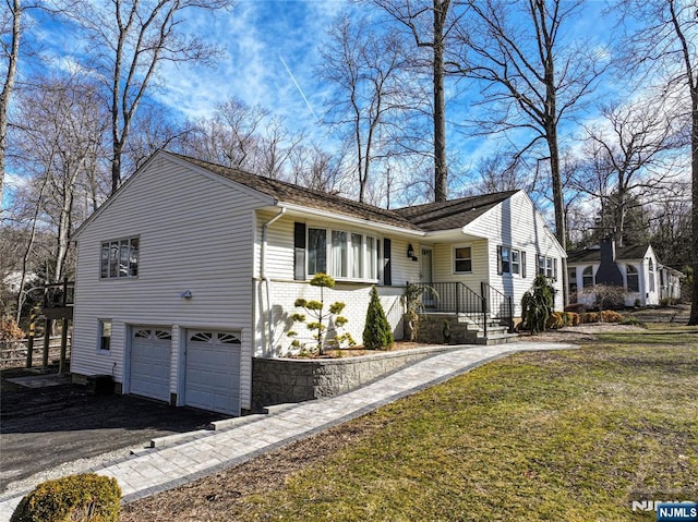 view of front facade with brick siding, an attached garage, and aphalt driveway