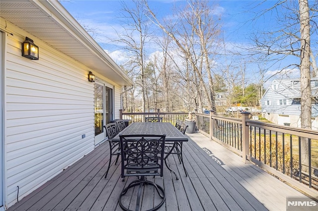 wooden terrace with outdoor dining space