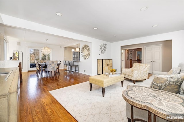 living room with recessed lighting, wood finished floors, and baseboards