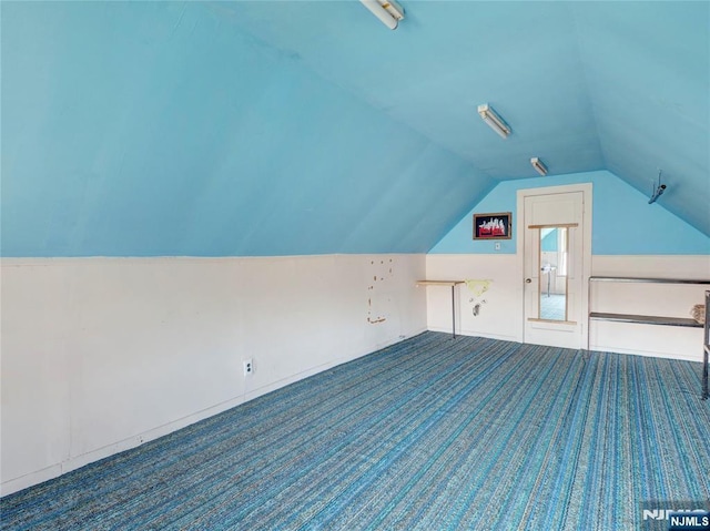 bonus room featuring vaulted ceiling and carpet floors