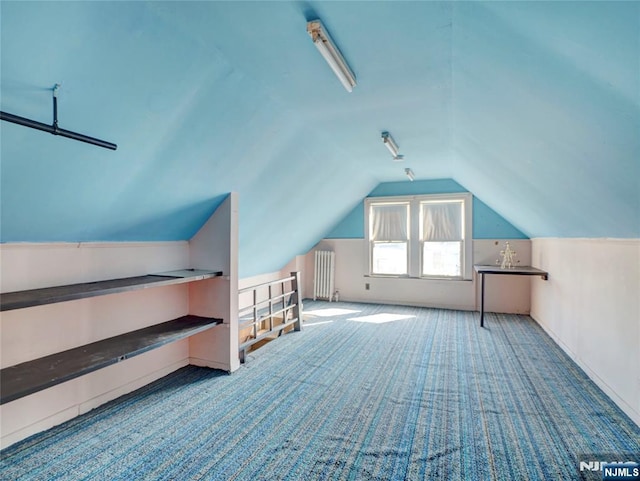 bonus room with carpet flooring, lofted ceiling, and radiator heating unit