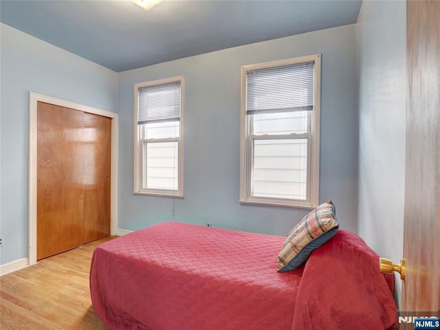 bedroom featuring baseboards and wood finished floors