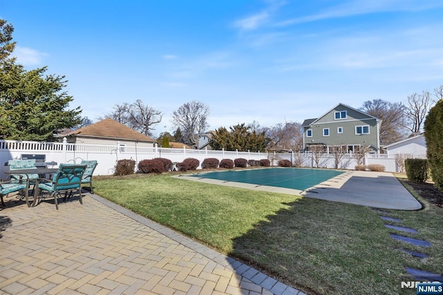 view of swimming pool featuring a yard, a patio area, a fenced in pool, and a fenced backyard