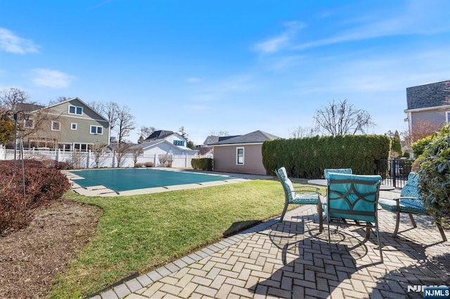 view of swimming pool featuring a fenced in pool, fence, an outdoor structure, a yard, and a patio area