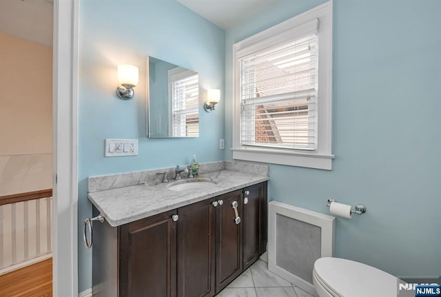 bathroom featuring toilet, marble finish floor, and vanity