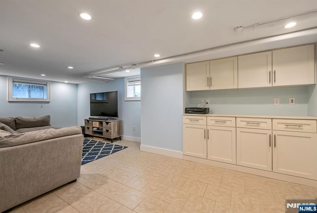 living room featuring recessed lighting and baseboards