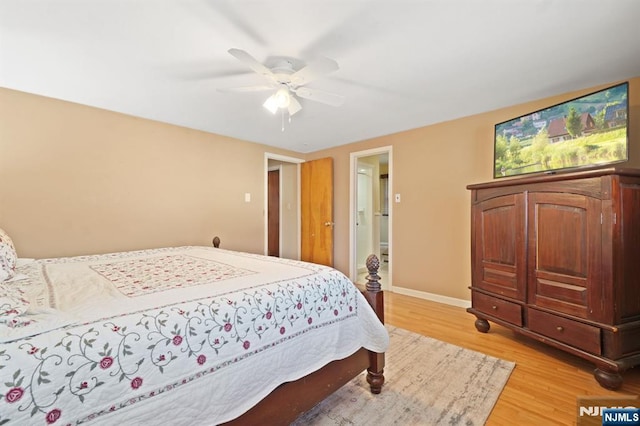 bedroom with baseboards, light wood-style flooring, and a ceiling fan